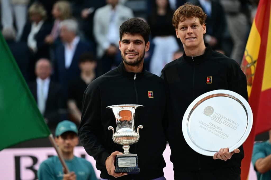 Spain's Carlos Alcaraz (l) and Italy's Jannik Sinner (r) pose for pictures at the end of their men's singles final match for the ATP Rome Open tennis tournament at Foro Italico in Rome on May 18, 2025. (Photo by Tiziana FABI / AFP)