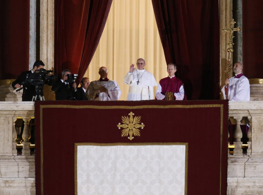 New pope: What name he chooses can signal what's ahead. FILE - Pope Francis flanked by Monsignor Guido Marini, master of liturgical ceremonies, waves to the crowd from the central balcony of St. Peter's Basilica at the Vatican, Wednesday, March 13, 2013. (AP Photo/Michael Sohn, File)